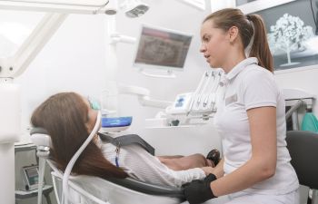 Dentist Talking To Her Patient After Putting Inhalation Sedation