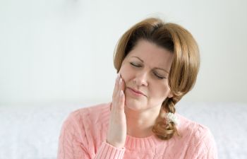 a mature woman suffering from toothache