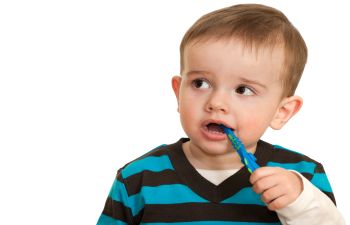 Baby boy with Toothbrush in His Mouth