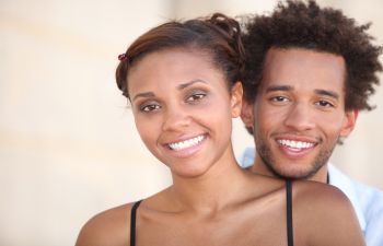 happy Afro-American young couple with perfect smiles