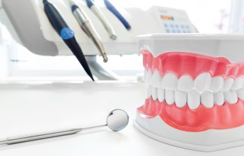 a dental model and a dentist's mirror by a dental machine