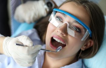 A young woman undergoing dental cleaning and checkup